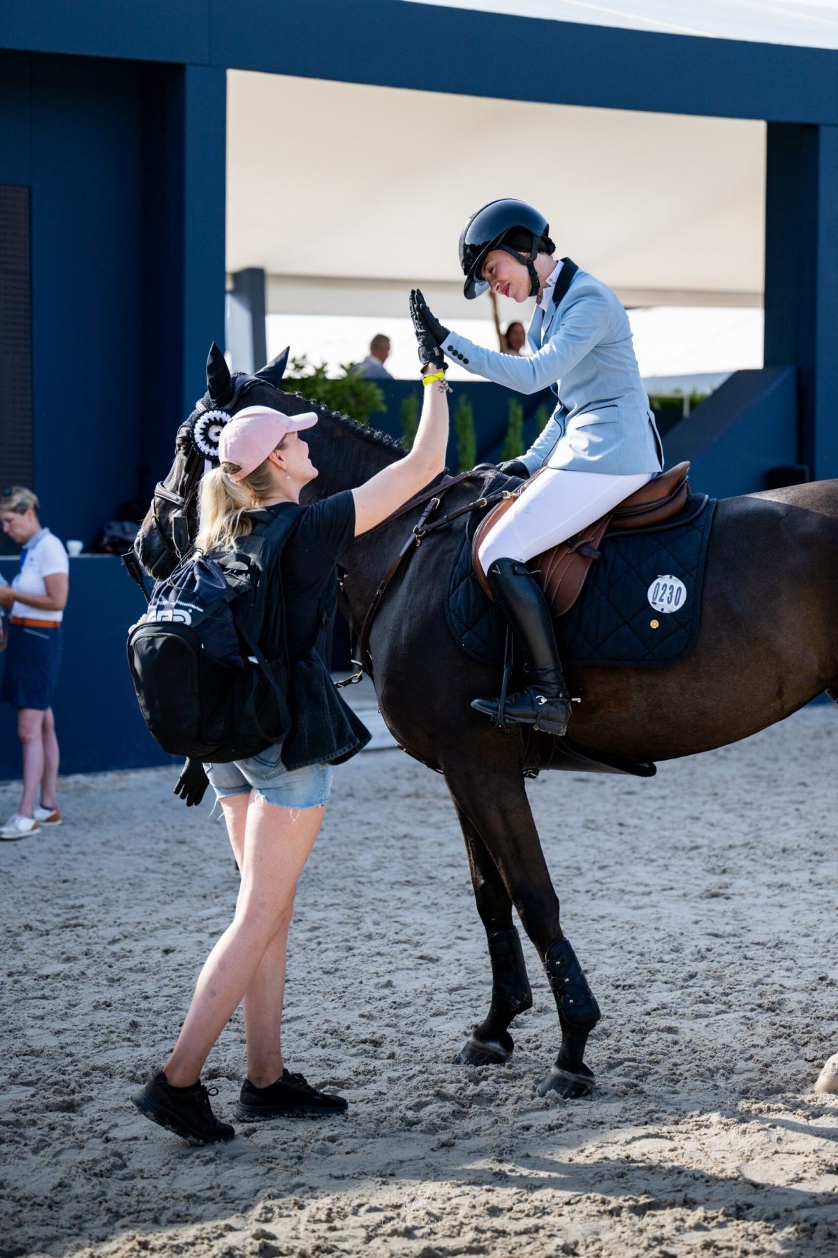 High-five with a rider at a competition